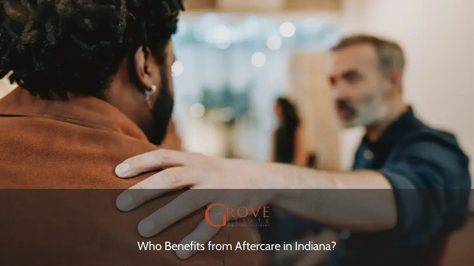Supportive interaction between two men during a therapeutic session, emphasizing compassion and community in aftercare settings.