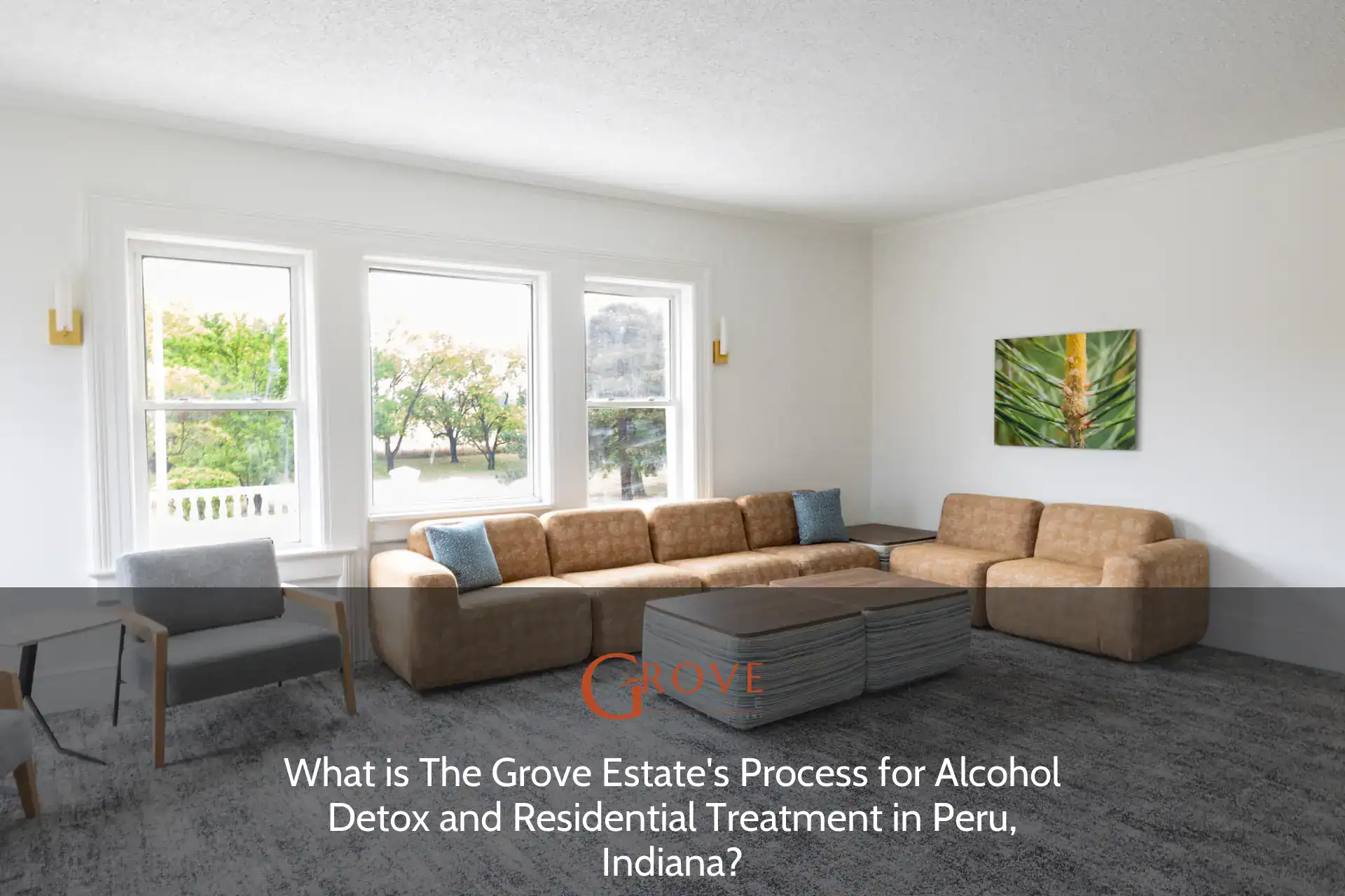 Bright and inviting lounge area at The Grove Estate, featuring modern seating, large windows, and a nature-themed artwork, perfect for relaxation.