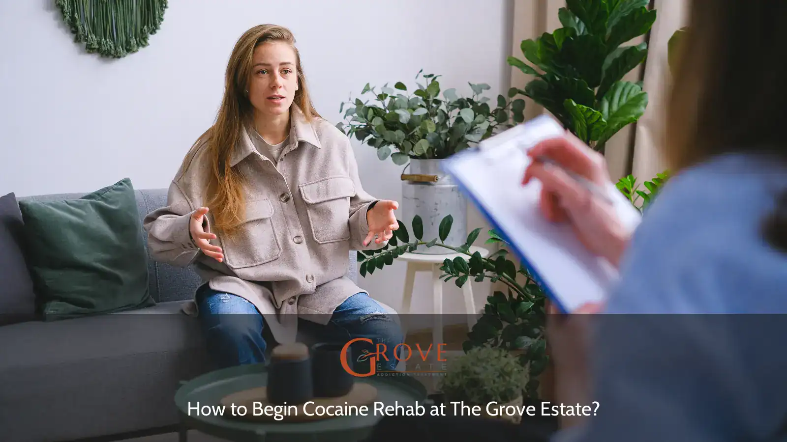 A young woman expresses herself during a therapy session at The Grove Estate, discussing her journey in rehabilitation with a notepad in view.