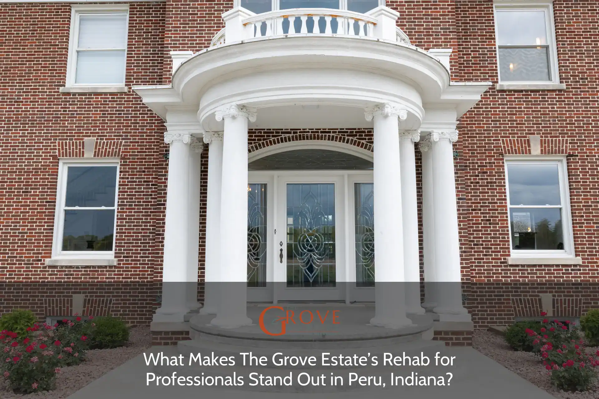 Elegant entrance of The Grove Estate in Peru, Indiana, featuring classical white columns, intricate glass doors, and vibrant flower beds.