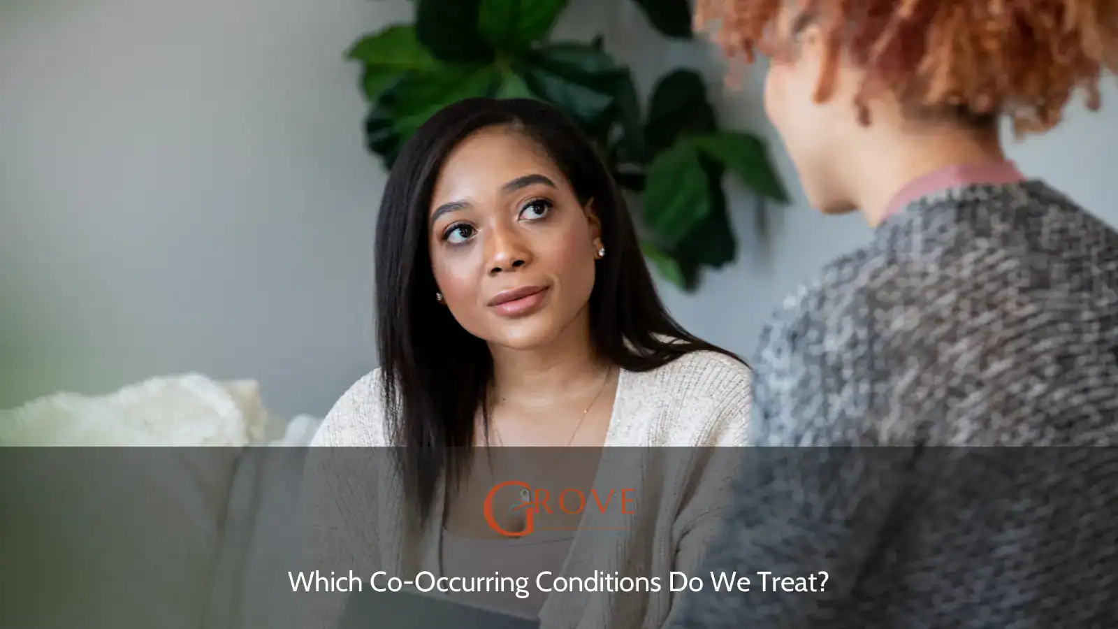 Two women engage in a conversation in a well-lit room, emphasizing connection while discussing co-occurring conditions in a supportive setting.