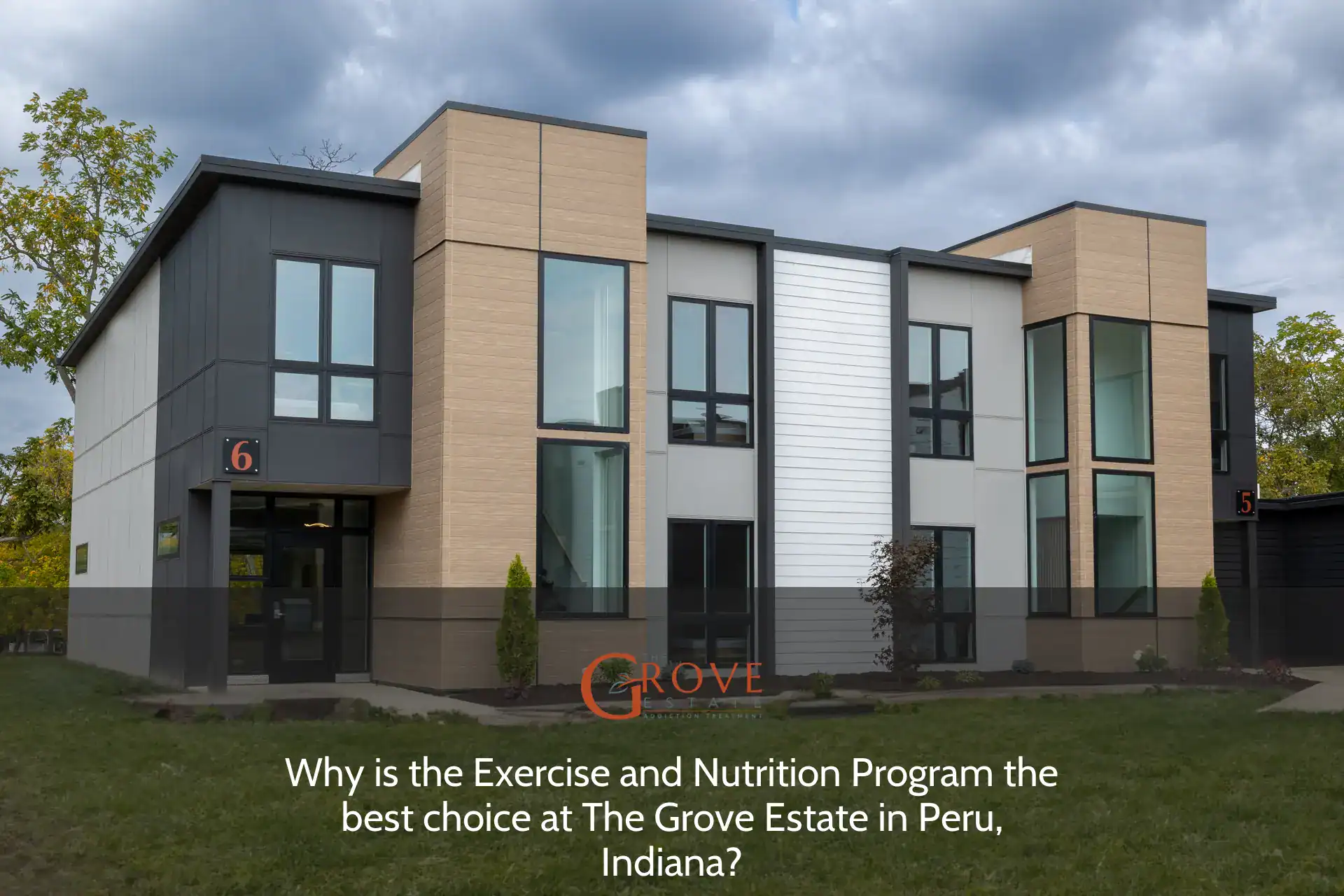 Modern duplex at The Grove Estate in Peru, Indiana, featuring large windows, contemporary design, and manicured landscaping. Unit numbers 5 and 6 visible.