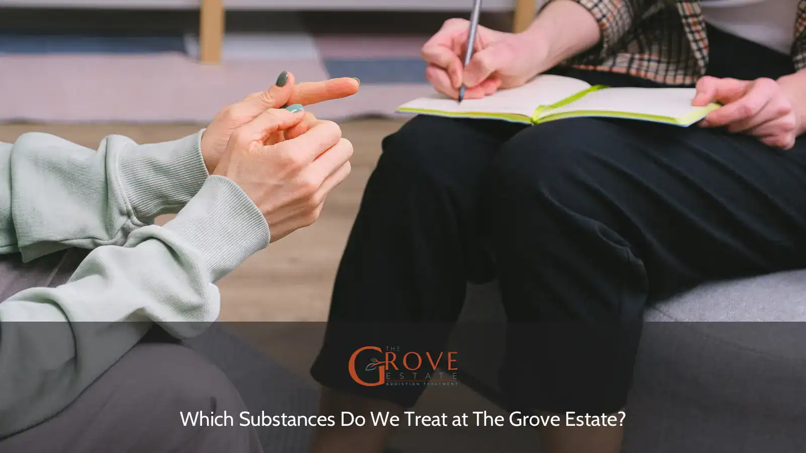 Hands gesturing during a conversation, as one person takes notes in a notebook, reflecting the therapeutic process at The Grove Estate.